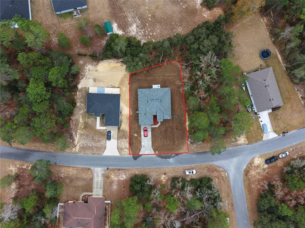 An aerial view shows a single-family home on a lot outlined in red — 15777 SW 55TH AVENUE ROAD, OCALA, FL