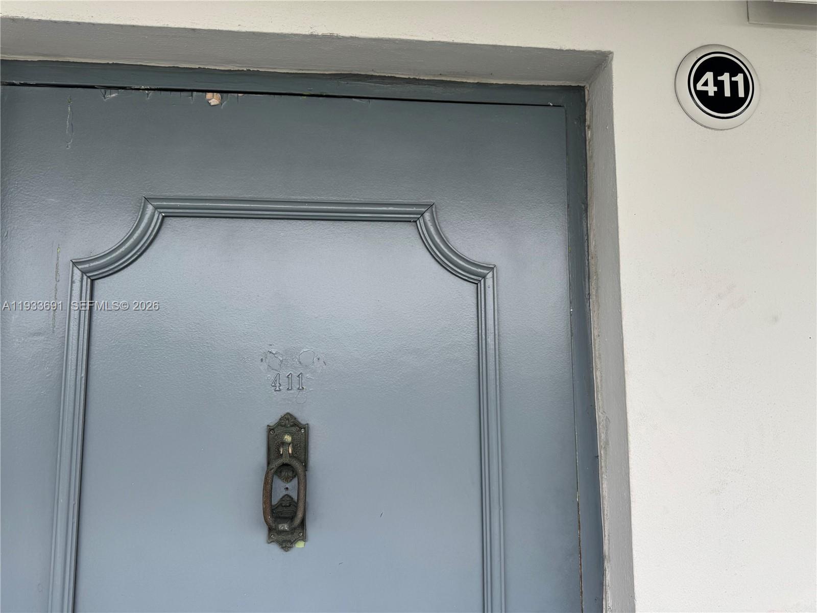 A gray door features a metal door knocker and the number 411 above it — 950 Hillcrest Dr # 411, Hollywood FL 33021, HOLLYWOOD, FL