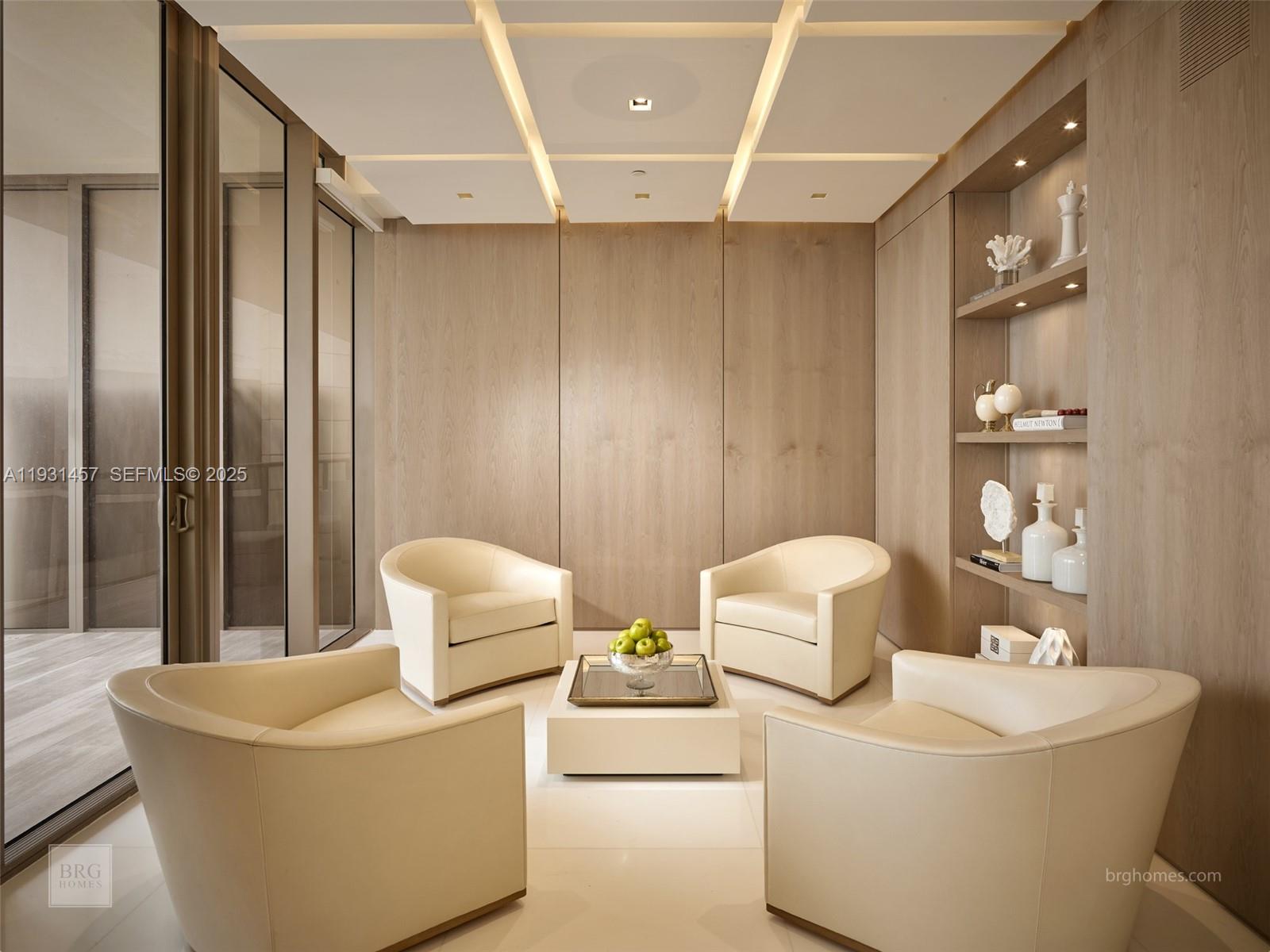 A modern seating area features four cream armchairs, a central coffee table, and wood-paneled walls — 9701 Collins Ave # 2704S, Bal Harbour FL 33154, BAL HARBOUR, FL