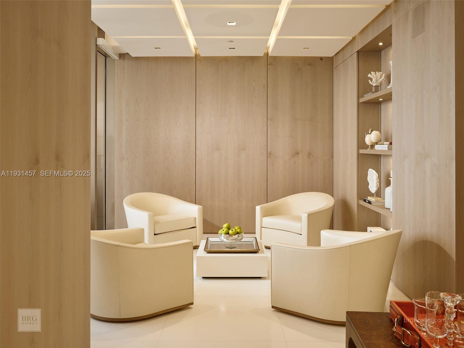 A modern seating area features four cream armchairs around a white coffee table against wood-paneled walls — 9701 Collins Ave # 2704S, Bal Harbour FL 33154, BAL HARBOUR, FL