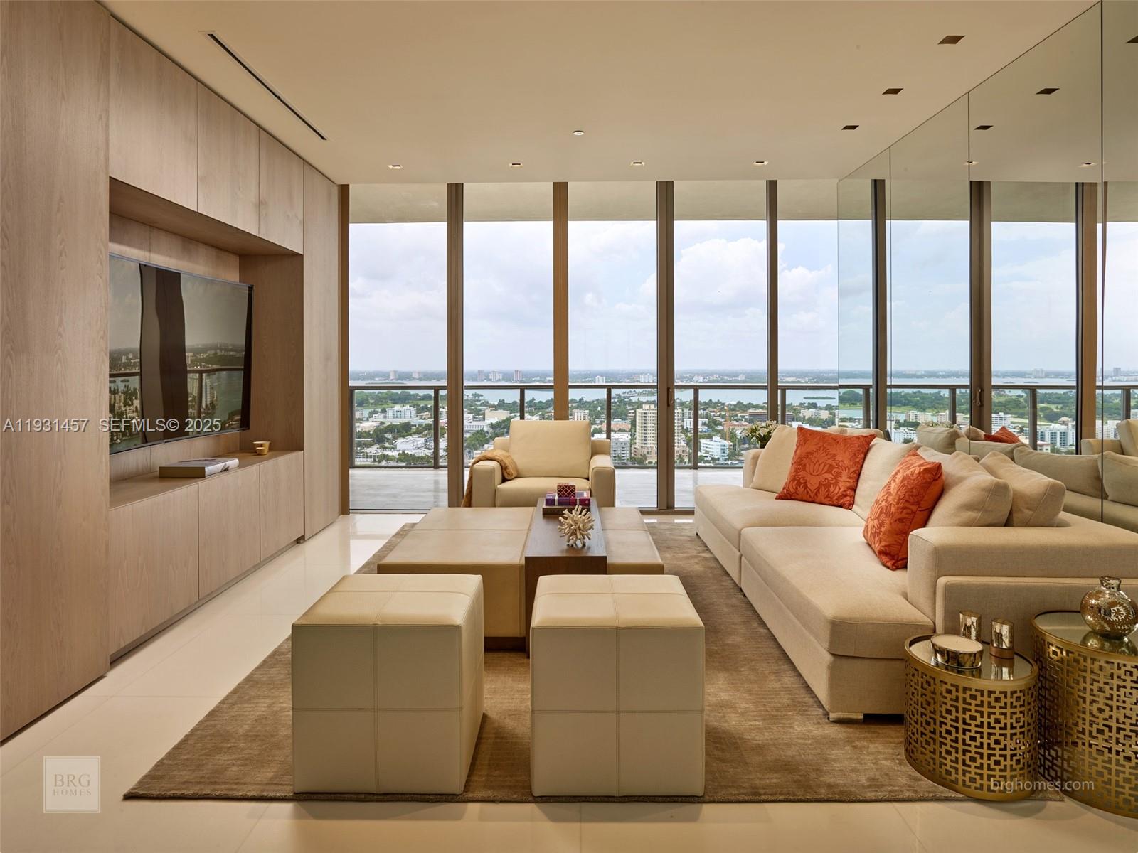 A modern living room features light wood cabinetry, a large sofa, and floor-to-ceiling windows — 9701 Collins Ave # 2704S, Bal Harbour FL 33154, BAL HARBOUR, FL