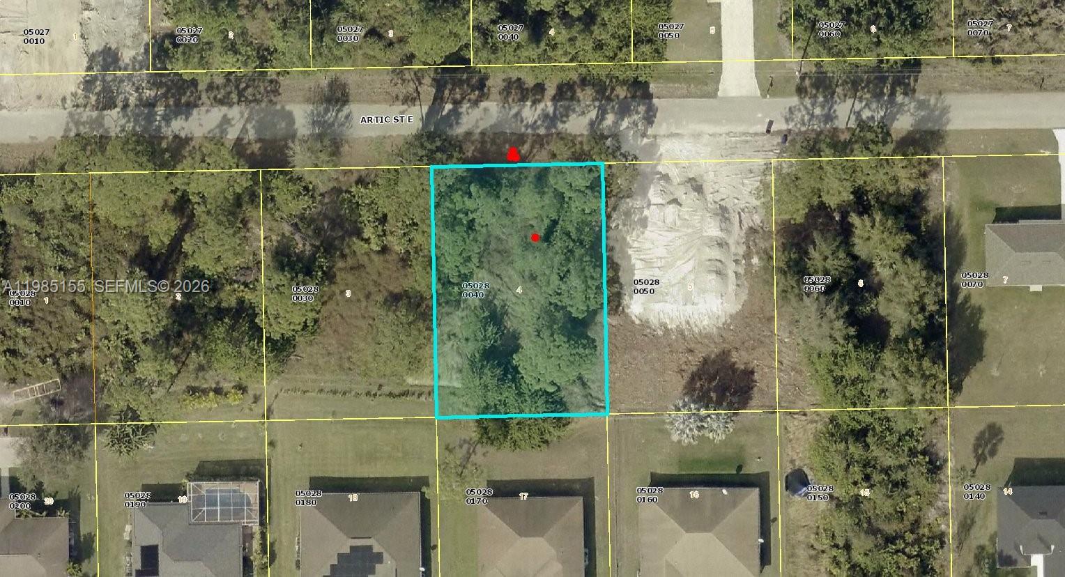 This is an aerial map showing a vacant, wooded rectangular lot highlighted in blue — 1110 Artic St E, Lehigh Acres FL 33974, LEHIGH ACRES, FL