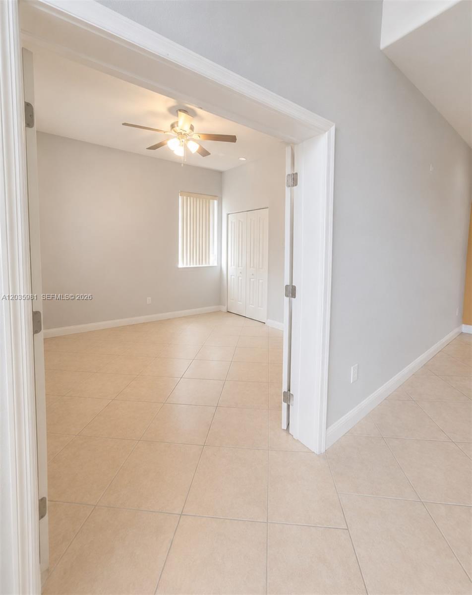 An interior view shows a room with tile flooring, a ceiling fan, and white doors — 7856 NW 167th Ter, Miami Lakes FL 33016, MIAMI LAKES, FL
