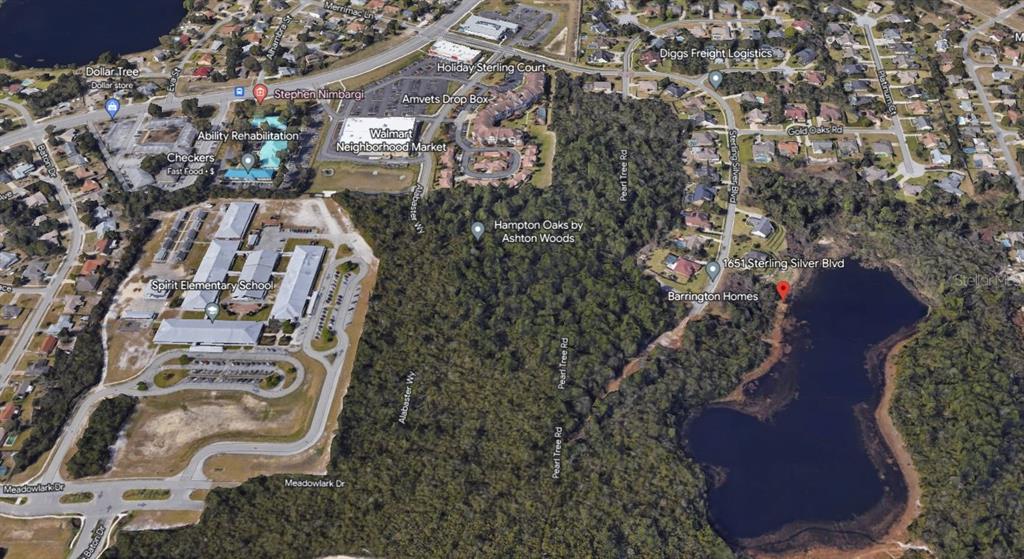 This is an aerial map view showing a residential neighborhood, a school, and a lake — 1651 STERLING SILVER BOULEVARD, DELTONA, FL