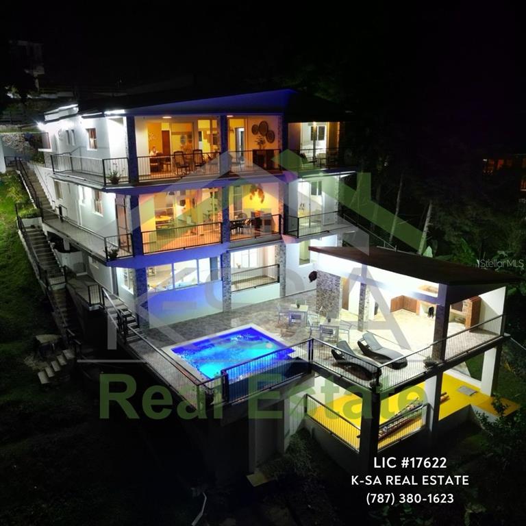 An aerial night view of a three-story house with balconies, a pool, and a patio — JAMACA DE DIOS CARRETERA PALO BLANCO, JARABACOA, KY