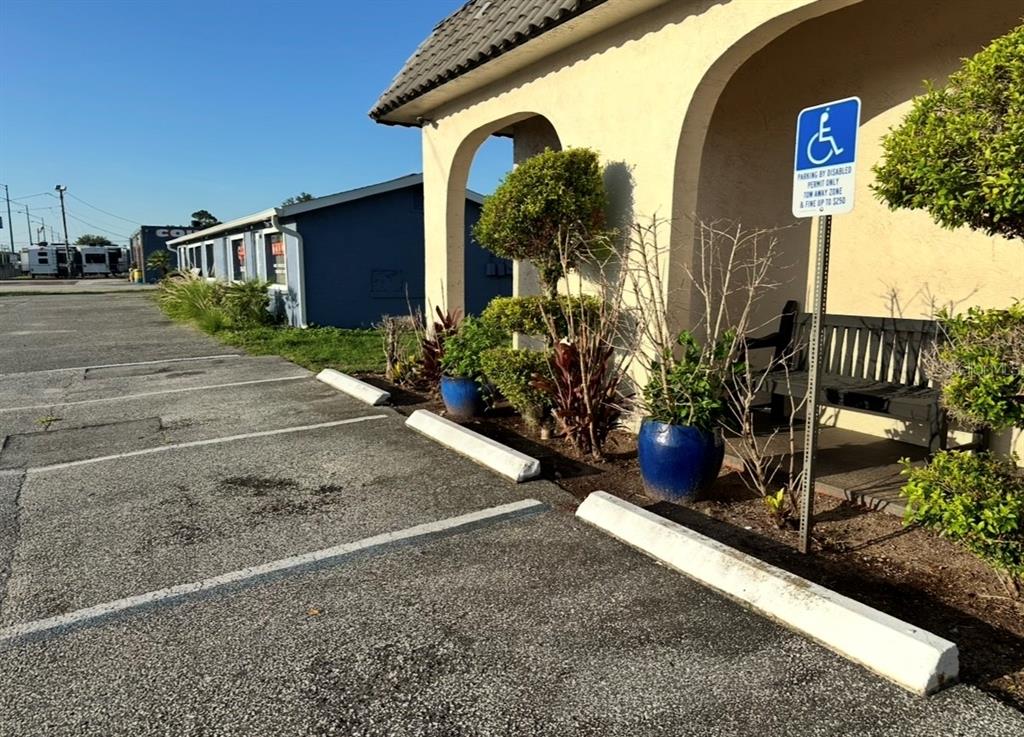 A parking space with a handicap sign sits in front of a building with arches — 1104 S NOVA ROAD, ORMOND BEACH, FL