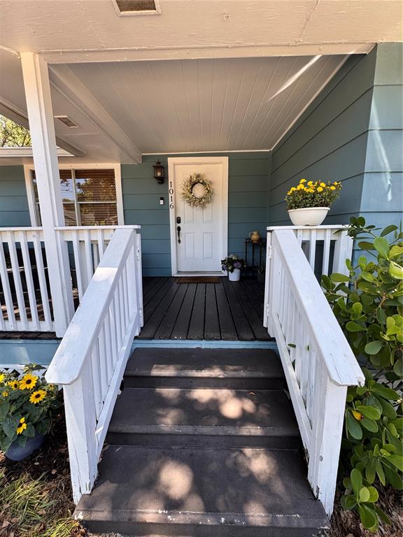 A front porch with white railings and steps leads to a white door with a wreath — 1016 E EMMA STREET, TAMPA, FL