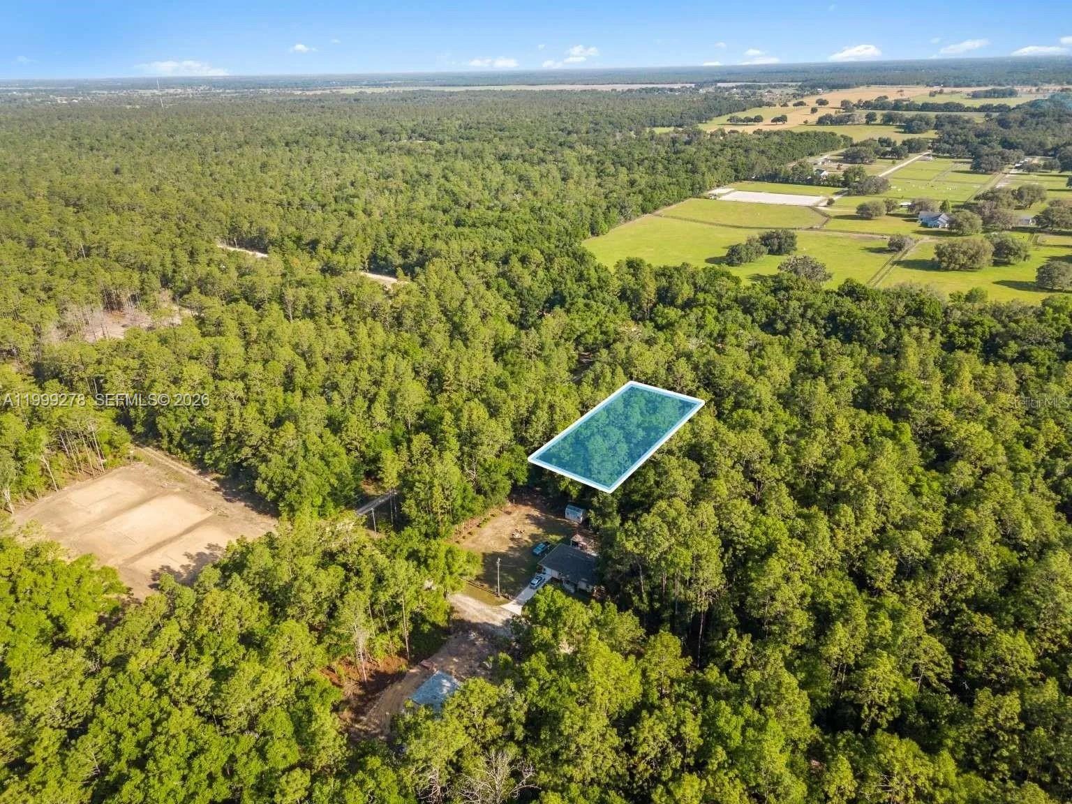 An aerial view shows a wooded lot with a highlighted rectangular area and a house — 0 SW 9th Place, Ocala FL 34481, OCALA, FL