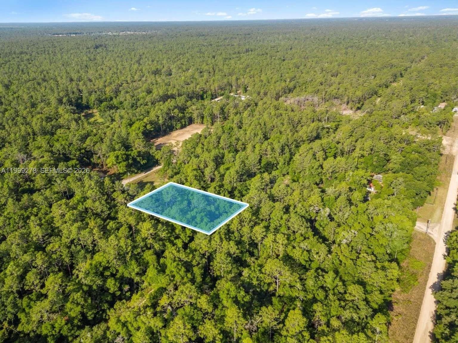 An aerial view shows a rectangular plot of land highlighted within a dense forest — 0 SW 9th Place, Ocala FL 34481, OCALA, FL