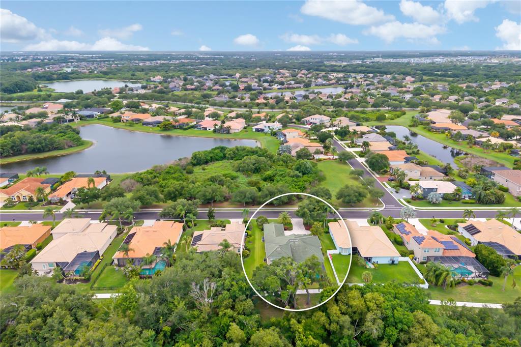 An aerial view shows the Bradenton Riverwalk, a long bridge, a marina, and palm trees — 12471 NATUREVIEW CIRCLE, BRADENTON, FL