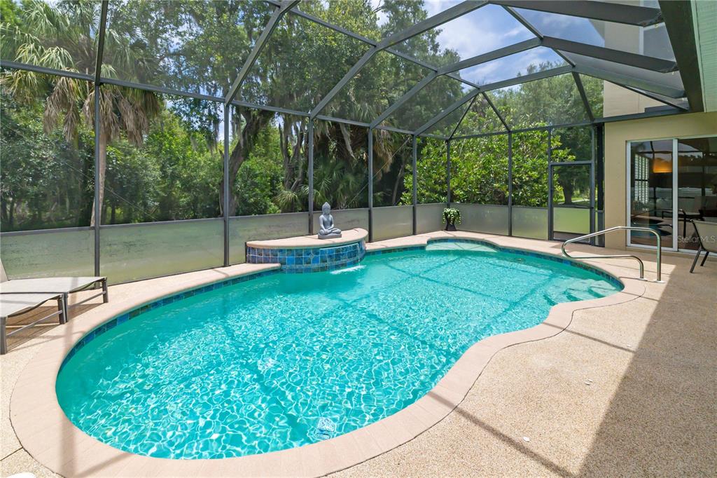 A single-story house with a paved driveway, stone accents, and a tile roof at sunset — 12471 NATUREVIEW CIRCLE, BRADENTON, FL