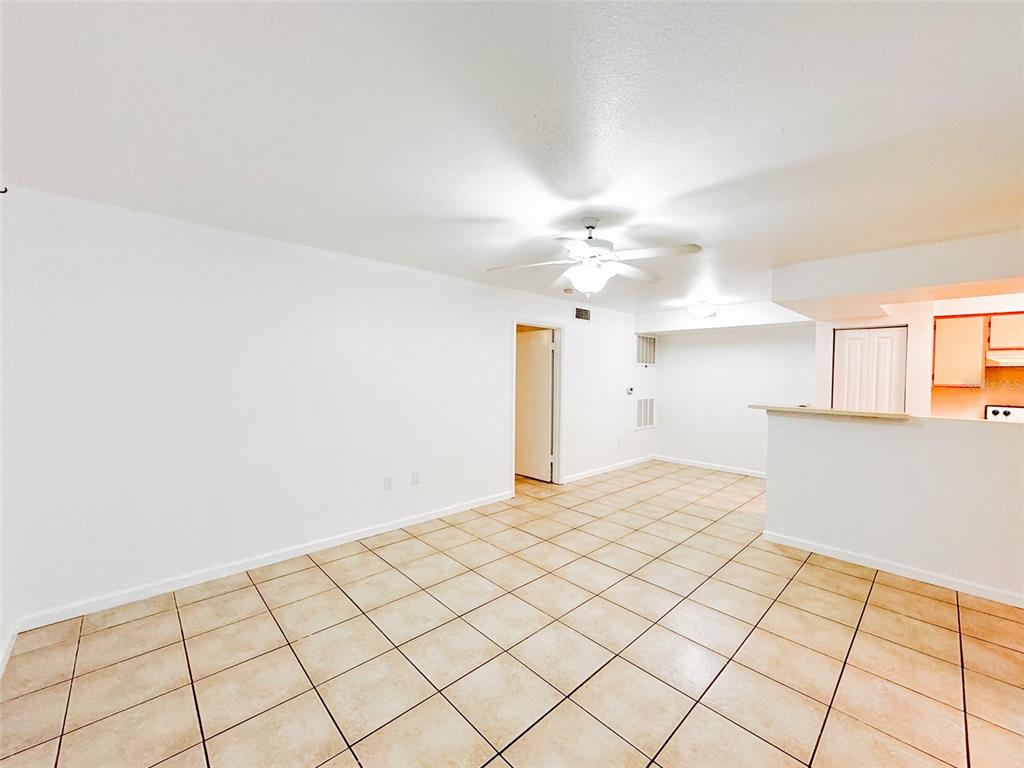 An empty room with white walls, tile flooring, and a ceiling fan — 3032 PARKWAY BOULEVARD UNIT 101, KISSIMMEE, FL