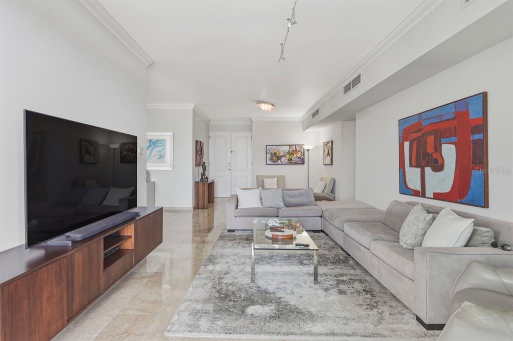 A living room features a large television, a sectional sofa, and a glass coffee table — Cond. Puerto Paseos AVENIDA FELISA RINCON GAUTIER UNIT 2104, SAN JUAN, PR
