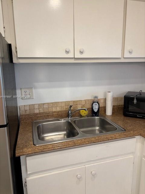 A kitchen features white cabinets, a double-basin stainless steel sink, and a brown countertop — 9493 SW 76th St # L4, Miami FL 33173, MIAMI, FL