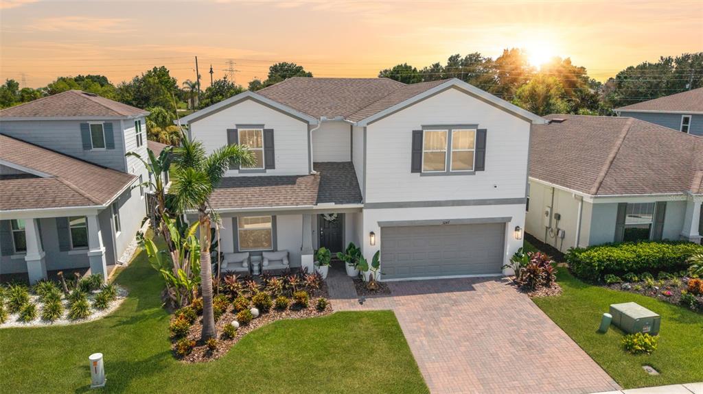 A two-story suburban house with a gray garage, white siding, and a paved driveway — 3247 BUOY CIRCLE, WINTER GARDEN, FL