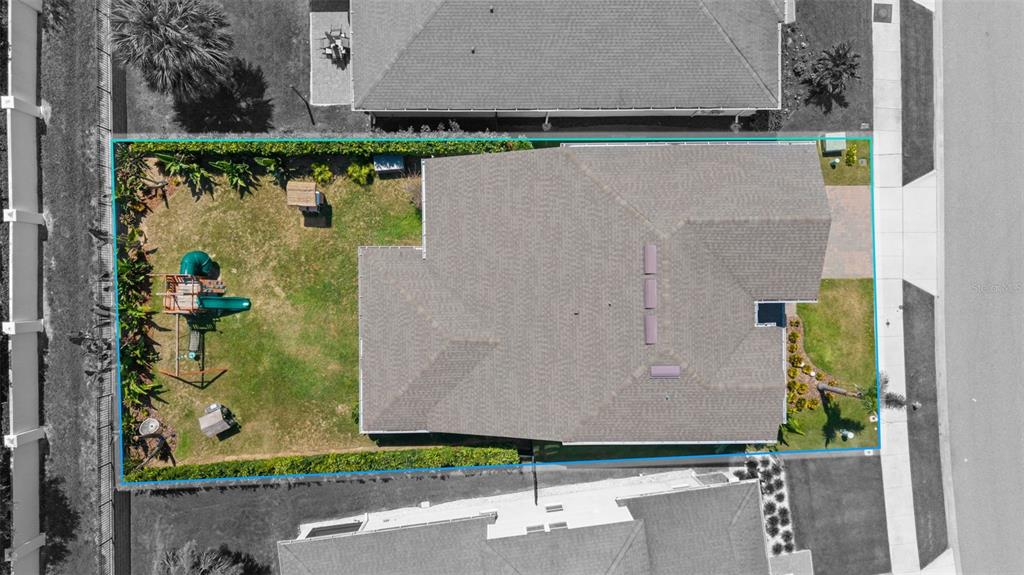 An aerial view shows a house with a fenced backyard containing a playground set — 3247 BUOY CIRCLE, WINTER GARDEN, FL