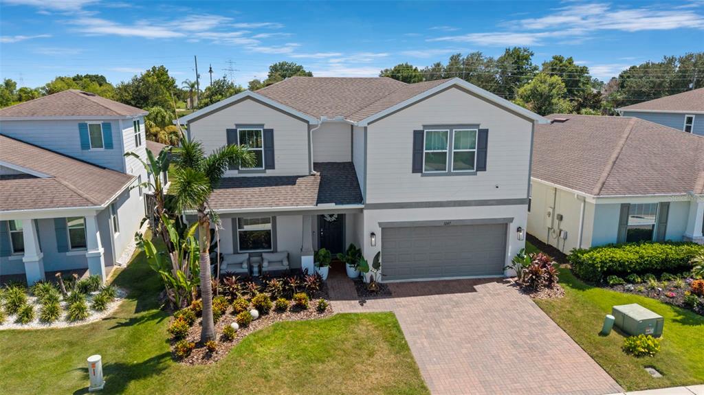 An aerial view of a two-story suburban house with a paved driveway and palm tree — 3247 BUOY CIRCLE, WINTER GARDEN, FL