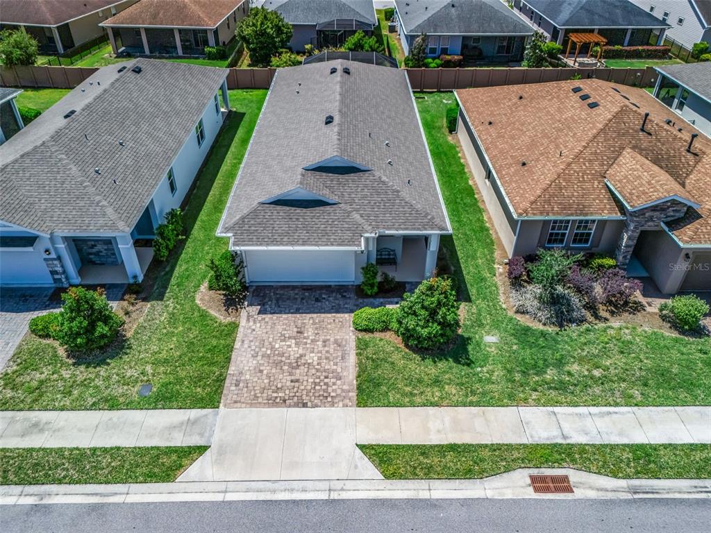 An aerial view shows a single-story house with a paver driveway and gray roof — 5536 NW 40TH LOOP, OCALA, FL