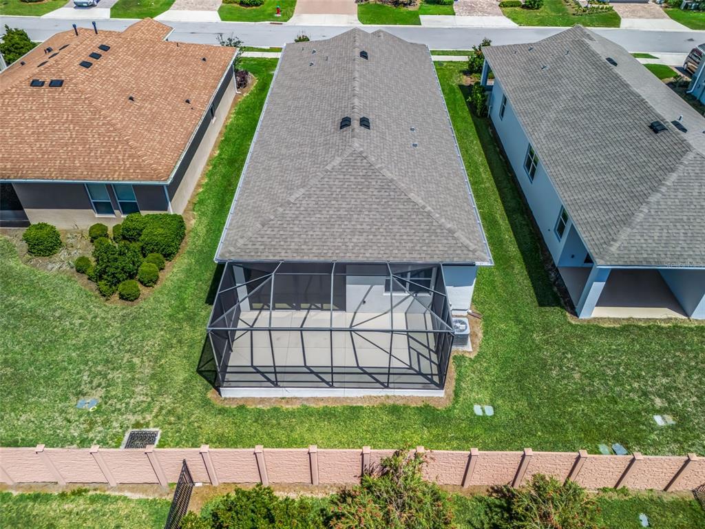 An aerial view shows a house with a gray roof and a screened-in back patio — 5536 NW 40TH LOOP, OCALA, FL