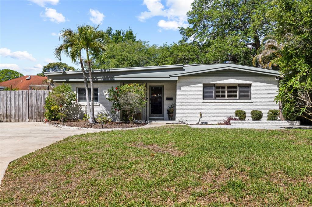 A single-story white brick house features a flat roof, palm trees, and a front lawn — 4303 S CAMERON AVENUE, TAMPA, FL