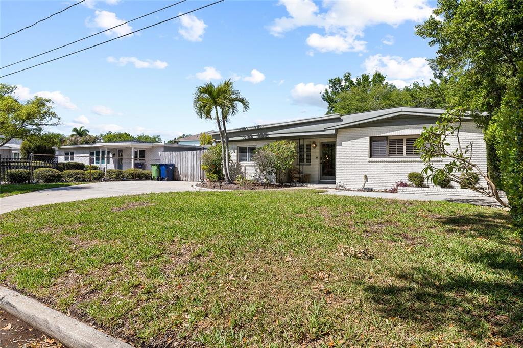 A single-story white brick house with a palm tree and a concrete driveway — 4303 S CAMERON AVENUE, TAMPA, FL