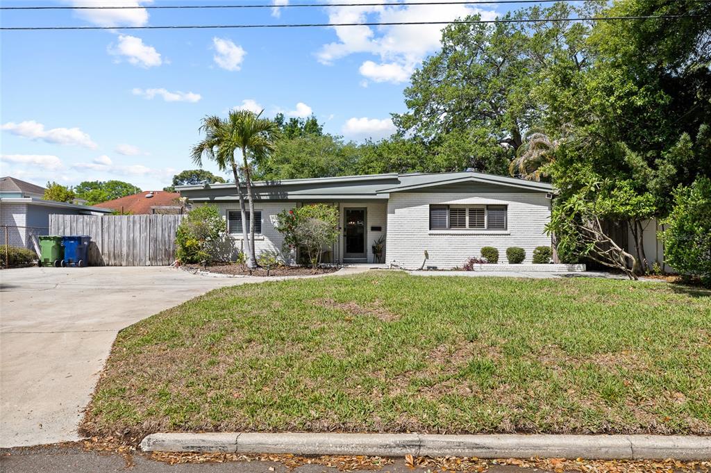 A single-story white brick house with a flat roof and a front lawn — 4303 S CAMERON AVENUE, TAMPA, FL