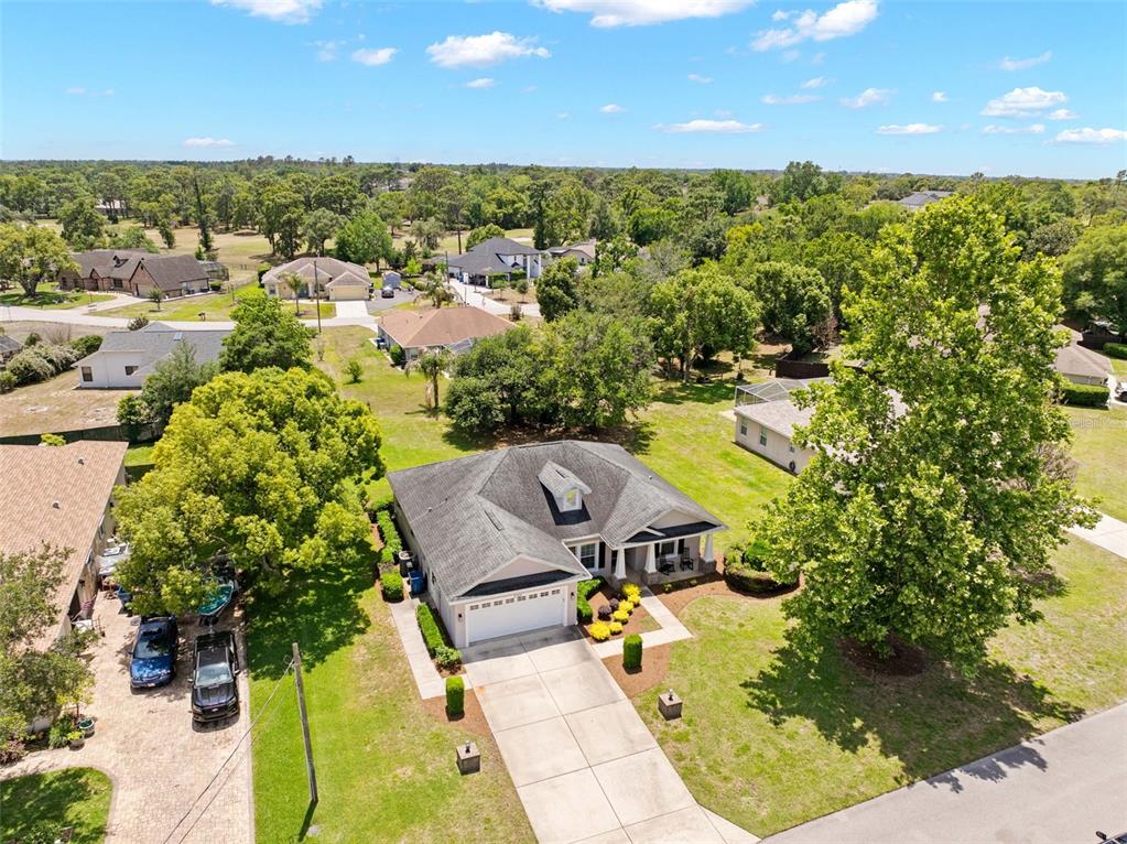 An aerial view shows a single-story house with a gray roof, garage, and driveway — 5384 SLATER ROAD, SPRING HILL, FL