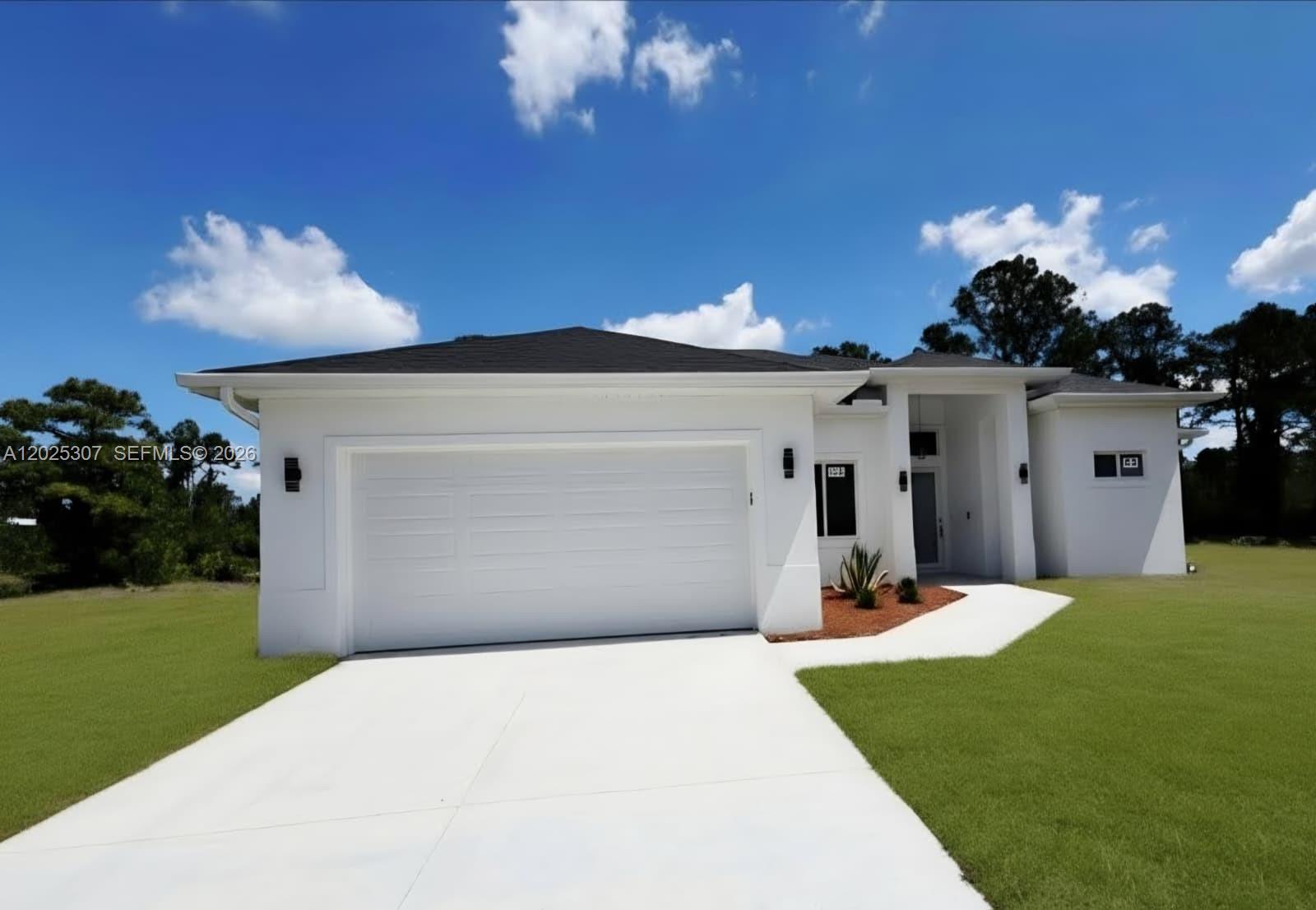 A white, single-story house with a two-car garage and a concrete driveway — 4007 E 13 ST, Lehigh Acres FL 33972, LEHIGH ACRES, FL