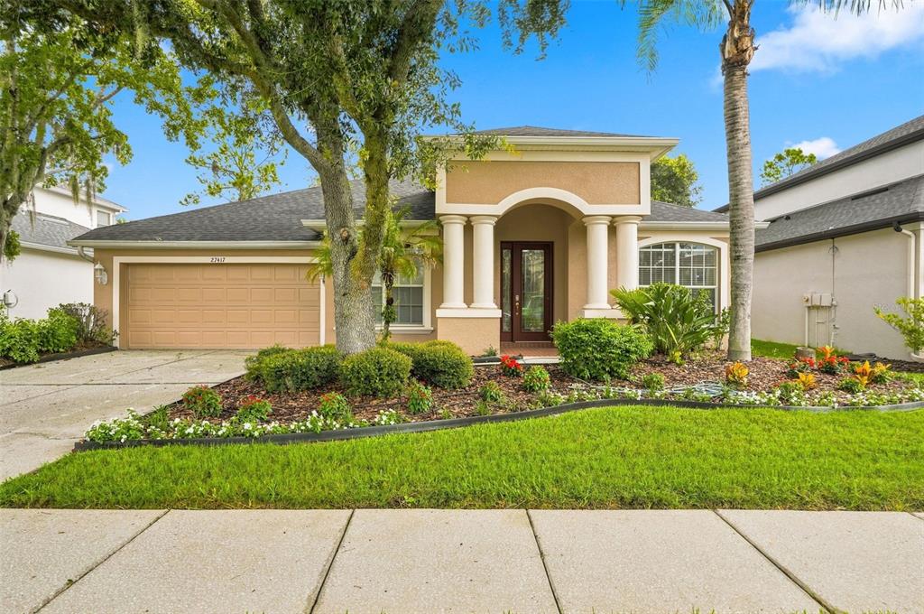 This is a floor plan for a single-story house with a screened patio and pool — 27417 SILVER THATCH DRIVE, WESLEY CHAPEL, FL