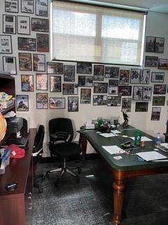 A home office features a large desk, a black chair, and walls covered in framed photos — 2810 NE 7th Avenue, Pompano Beach FL 33064, POMPANO BEACH, FL