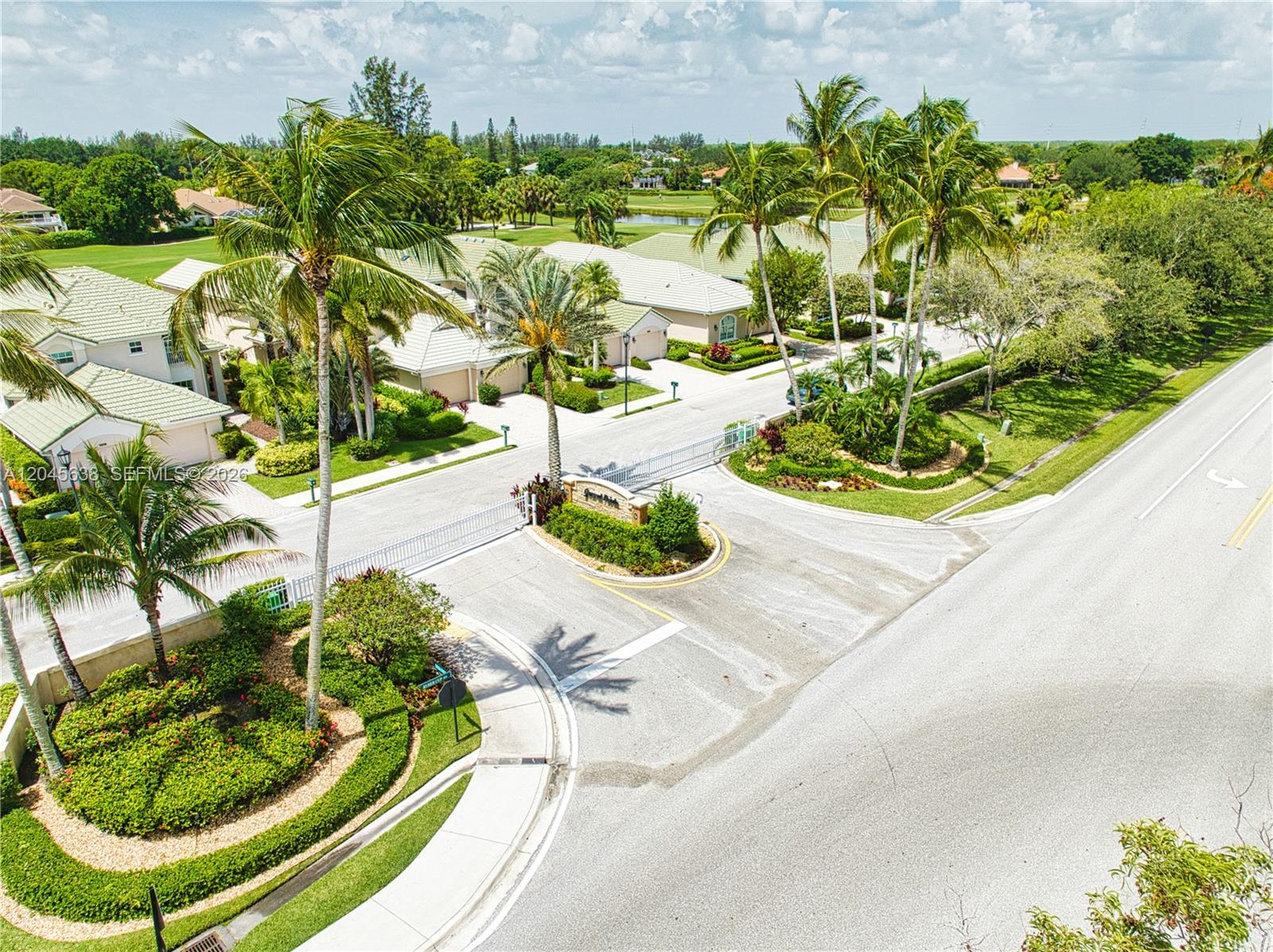 An aerial view shows the gated entrance to a residential community with palm trees — 1207 General Pointe Trce, Palm Beach Gardens FL 33418, PALM BEACH GARDENS, FL