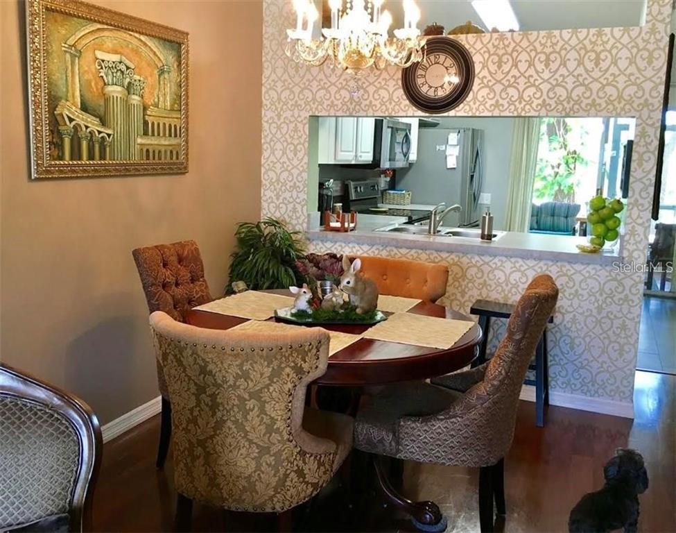 An empty bedroom features dark wood flooring, a ceiling fan, and a window with curtains — 2454 LAKE WOODBERRY CIRCLE, BRANDON, FL