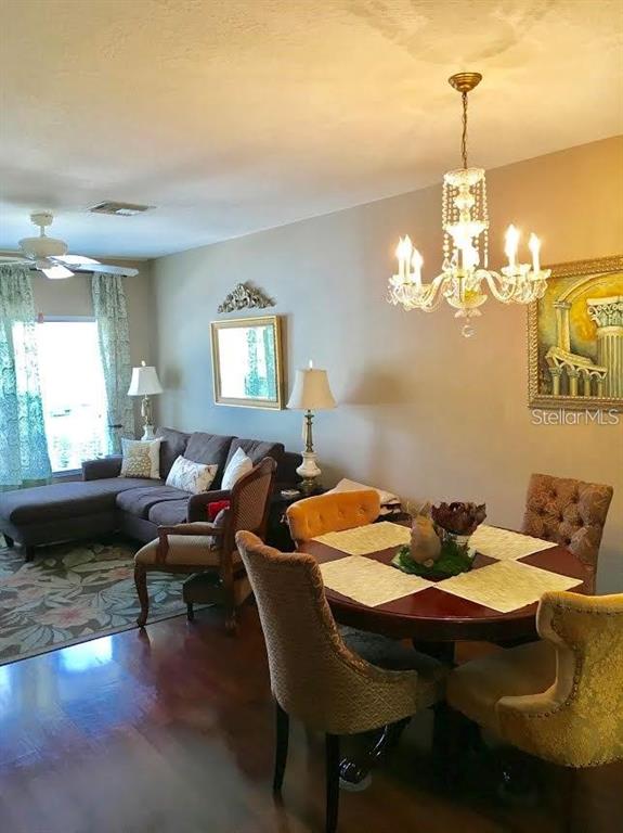 A bathroom features a white vanity, a toilet, and a shower with a patterned curtain — 2454 LAKE WOODBERRY CIRCLE, BRANDON, FL