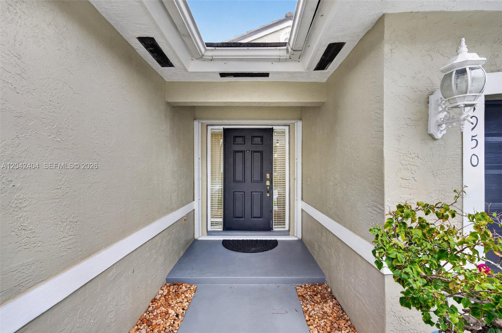 A front entryway features a black door, a skylight, and a concrete walkway — 4950 SW 152nd Ave, Miramar FL 33027, MIRAMAR, FL