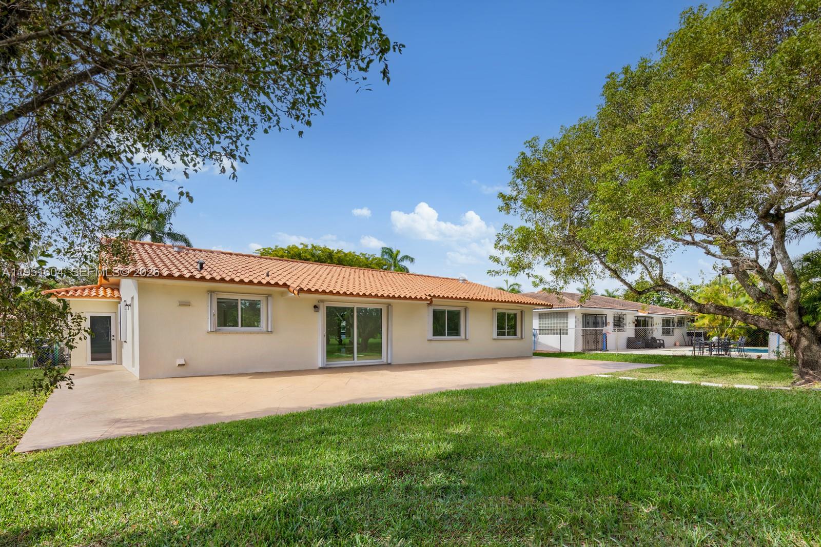 The exterior view shows a single-story house with a tiled roof, patio, and grassy yard — 2045 SW 125th Ct # 2045, Miami FL 33175, MIAMI, FL