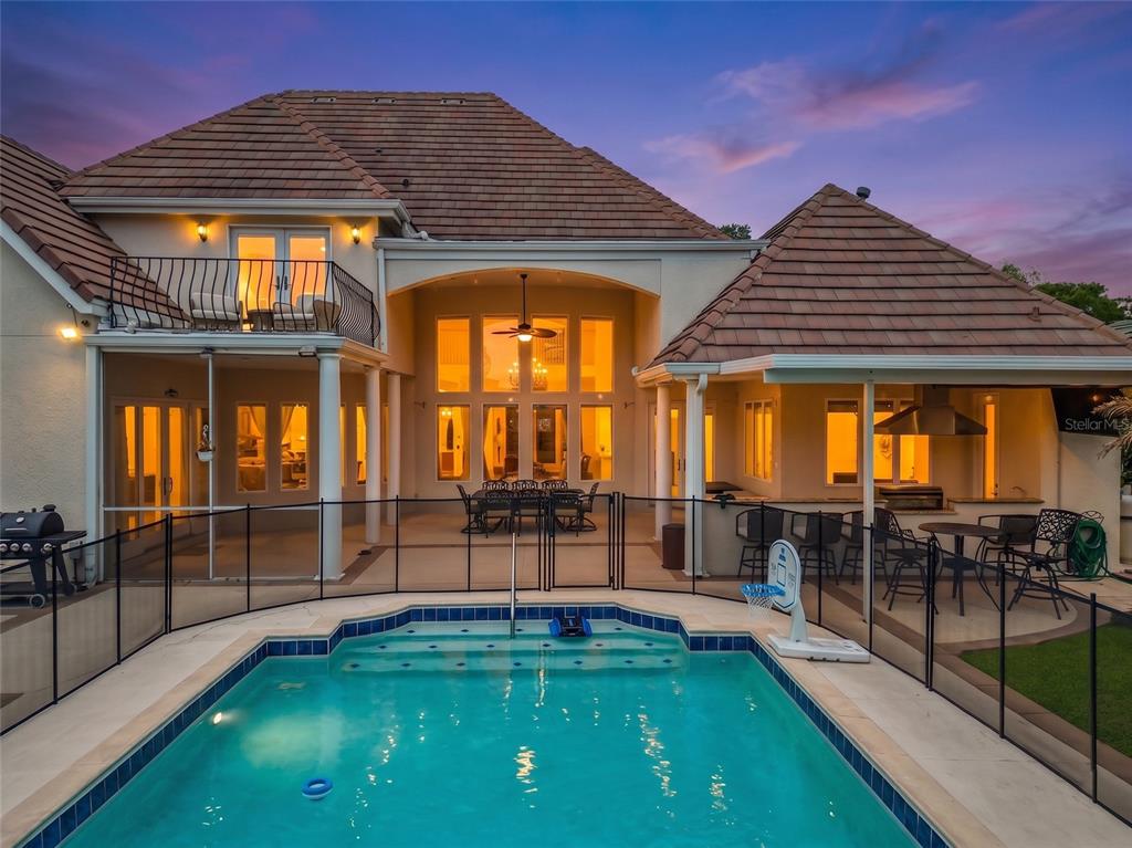 A two-story house with a swimming pool, patio, outdoor kitchen, and a second-floor balcony — 2204 CAIRNS COURT, ORLANDO, FL