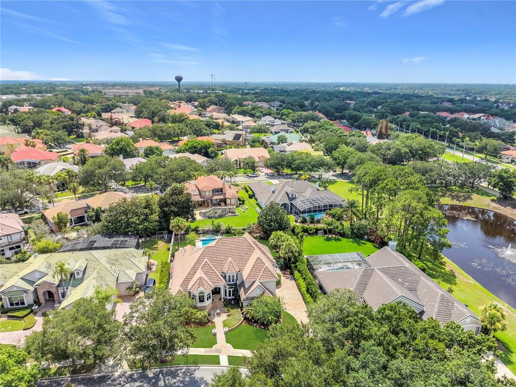An aerial view of a suburban neighborhood featuring several large houses with swimming pools — 2204 CAIRNS COURT, ORLANDO, FL