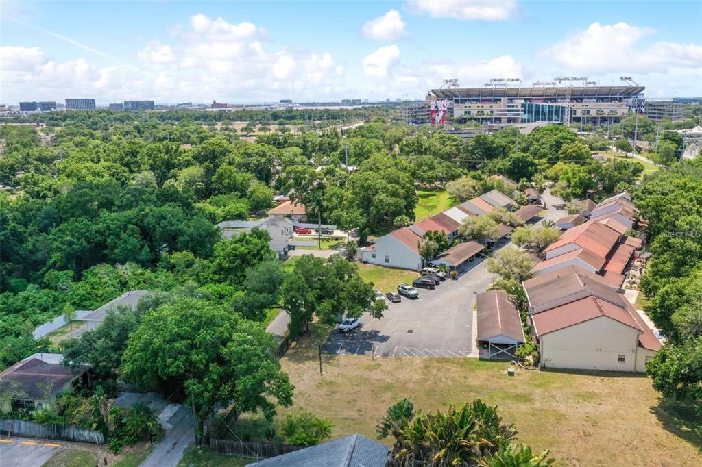 An aerial view shows a residential complex with parking lots near a large sports stadium — 3348 W HIDDEN HAVEN COURT, TAMPA, FL