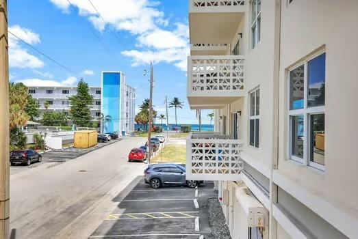 An exterior view of a multi-story building with balconies overlooking a street and the ocean — 1901 S Ocean Drive # 202, Hollywood FL 33019, HOLLYWOOD, FL