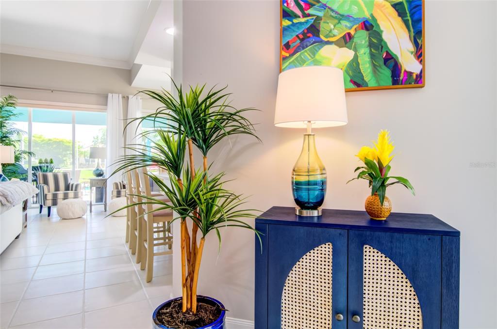 A blue cabinet with a lamp and plant sits in a room with a view — 5622 OCTONIA PLACE, SARASOTA, FL