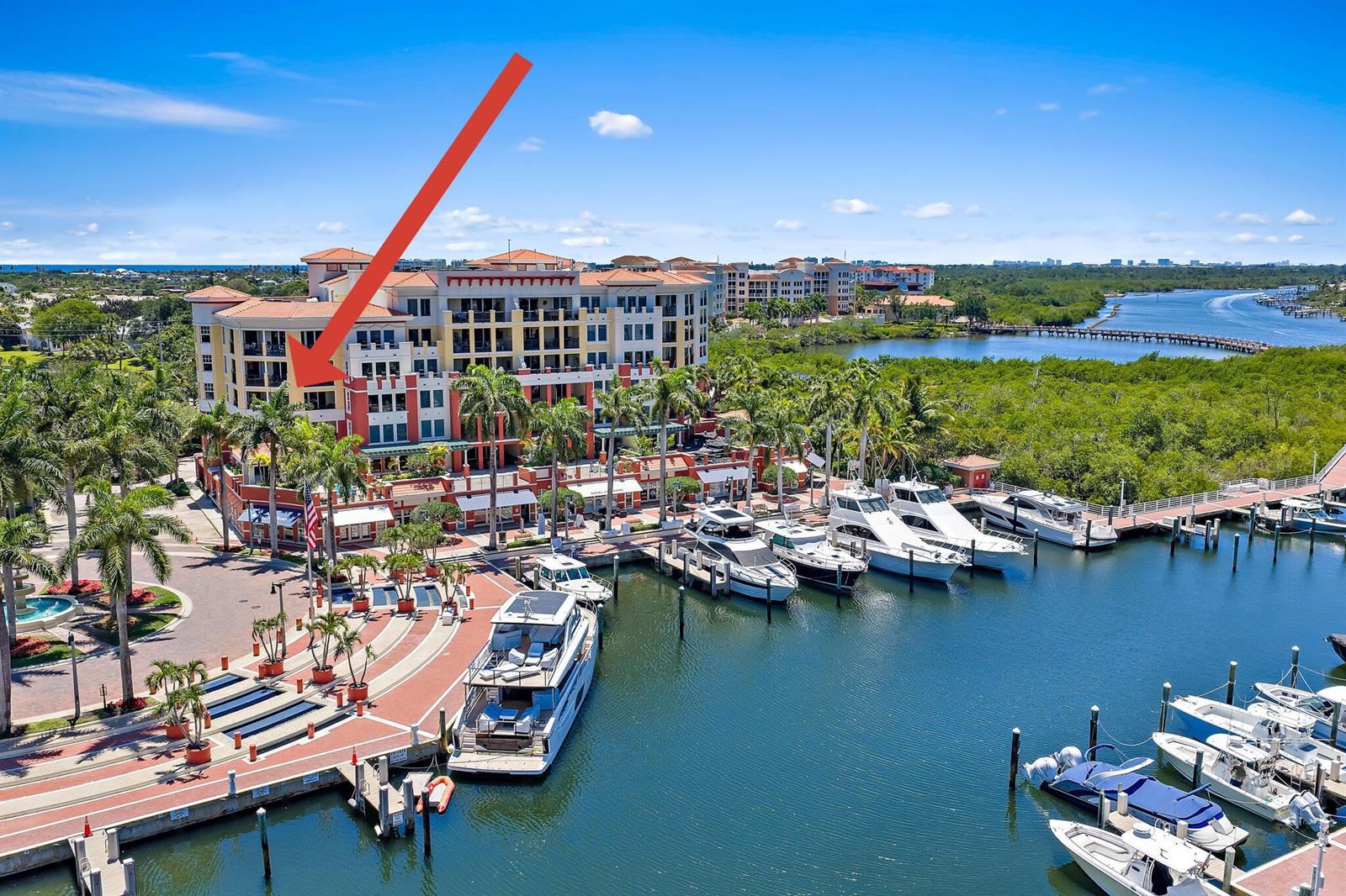 An aerial view shows a multi-story building with a marina and docked boats — 400 S Us Highway 1 # 304, Jupiter FL 33477, JUPITER, FL