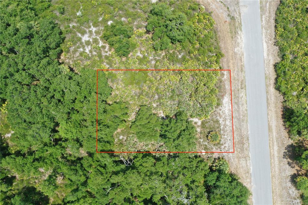 An aerial view shows a rectangular plot of land outlined in red next to a road — Lot 10 BRIXTON TERRACE, NORTH PORT, FL