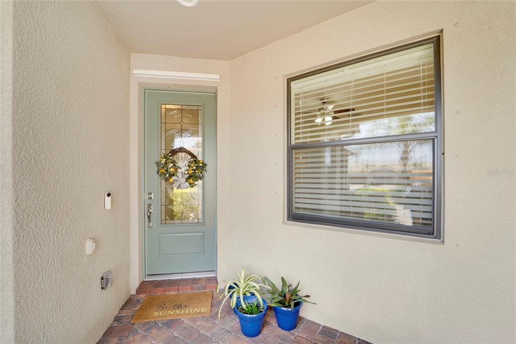 A front entryway features a light green door with a glass insert and a window — 13908 ALAFAYA STREET, VENICE, FL