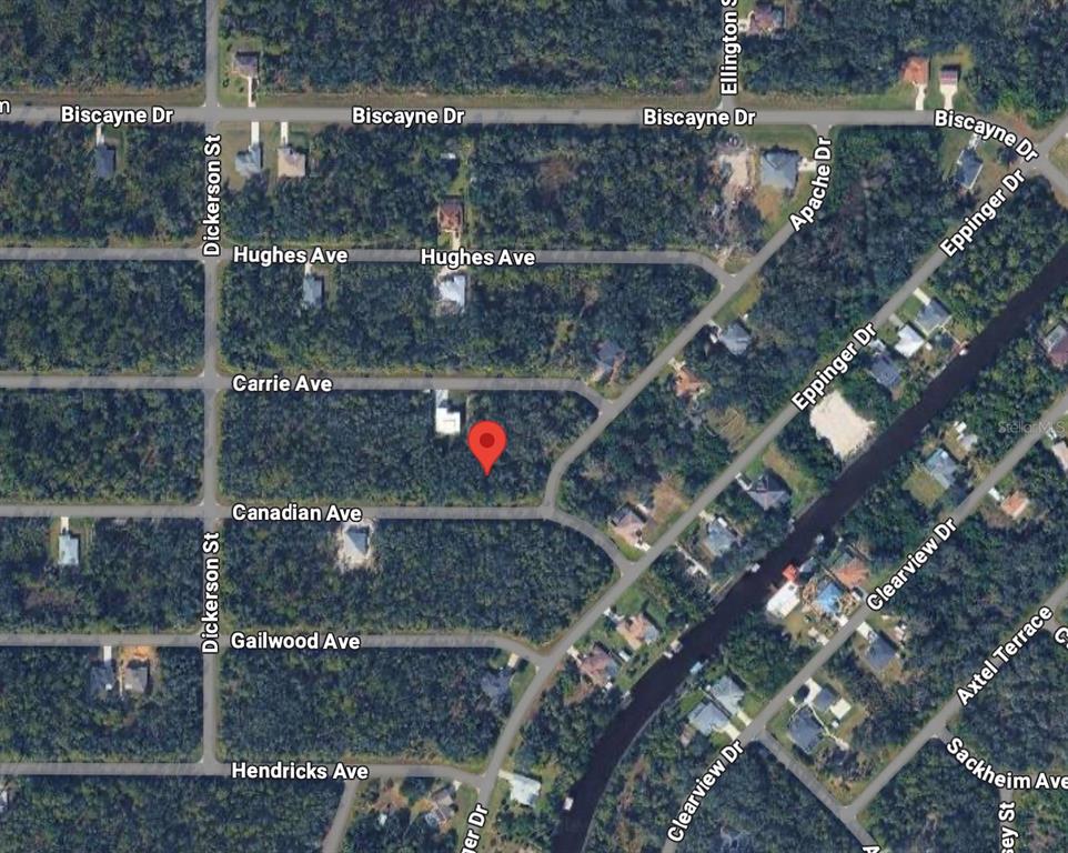 This is an aerial map showing a red location pin on a wooded residential lot — 14146 CANADIAN AVENUE, PORT CHARLOTTE, FL