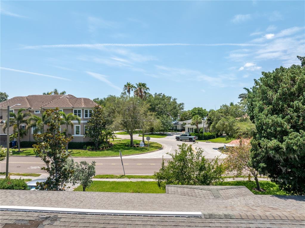 An elevated view shows a residential street with houses, trees, and a parked pickup truck — 167 ALMEDO WAY NE, ST PETERSBURG, FL