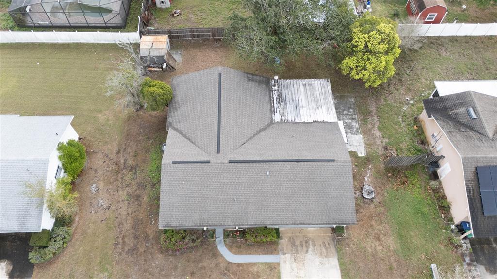 An aerial view shows a house with a shingled roof and a flat patio section — 2733 MIDDLE STREET, ORLANDO, FL