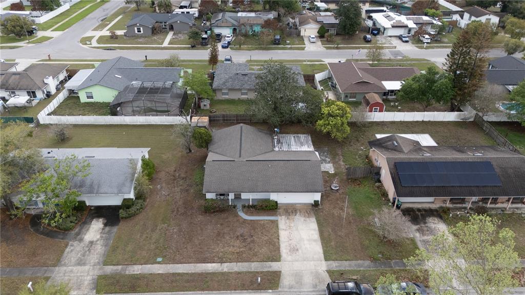 An aerial view shows a residential neighborhood with several single-story houses and paved driveways — 2733 MIDDLE STREET, ORLANDO, FL