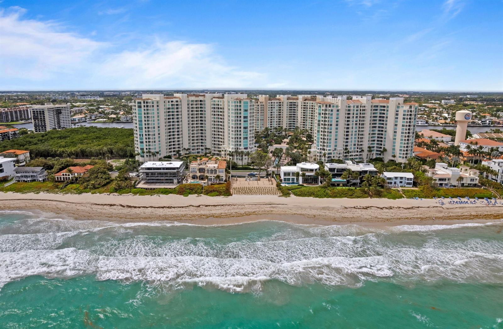 An aerial view shows a beachfront residential complex with high-rise buildings and private homes — 3723 S Ocean Boulevard, Highland Beach FL 33487, HIGHLAND BEACH, FL