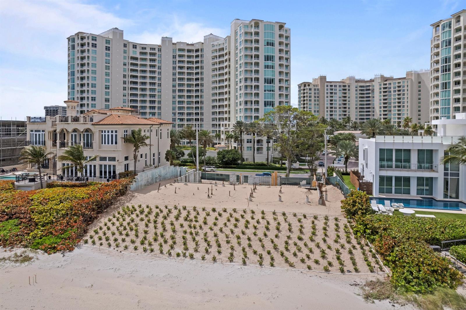 An aerial view shows a sandy beach lot with small plants in front of buildings — 3723 S Ocean Boulevard, Highland Beach FL 33487, HIGHLAND BEACH, FL