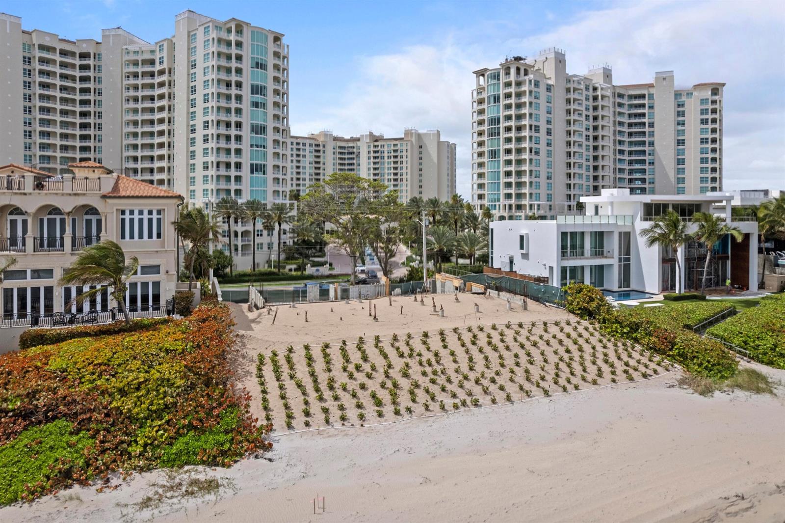An aerial view shows a sandy beach lot with small plantings between two large residential buildings — 3723 S Ocean Boulevard, Highland Beach FL 33487, HIGHLAND BEACH, FL